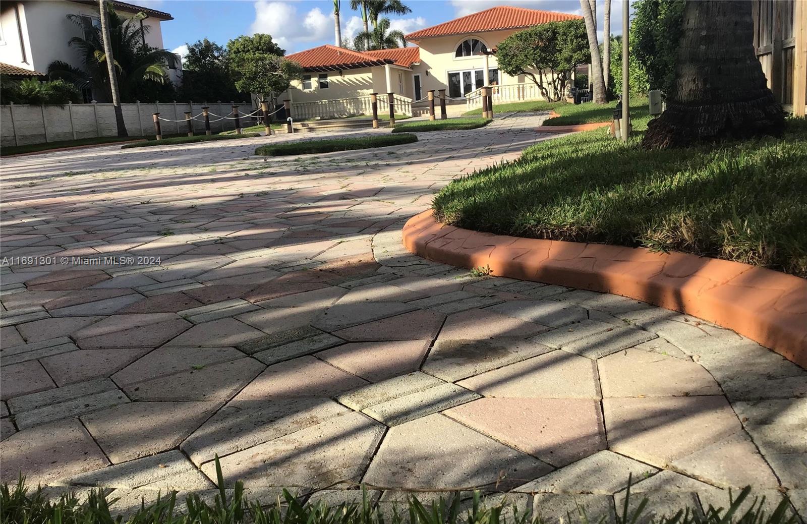 A paved driveway leads toward a house with a tiled roof and landscaped yard — 13460 SW 32nd ST, Kendall FL 33175, KENDALL, FL