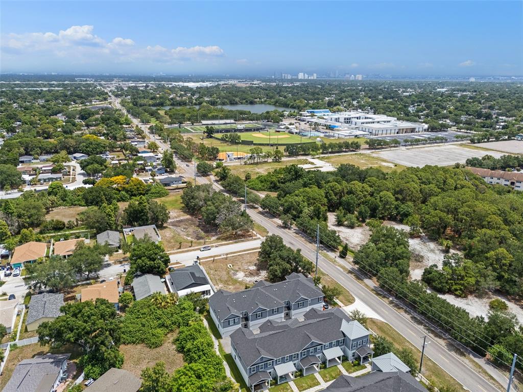 An aerial view shows a multi-unit residential building next to a road and green space — 6615 S MANHATTAN AVENUE UNIT 3, TAMPA, FL