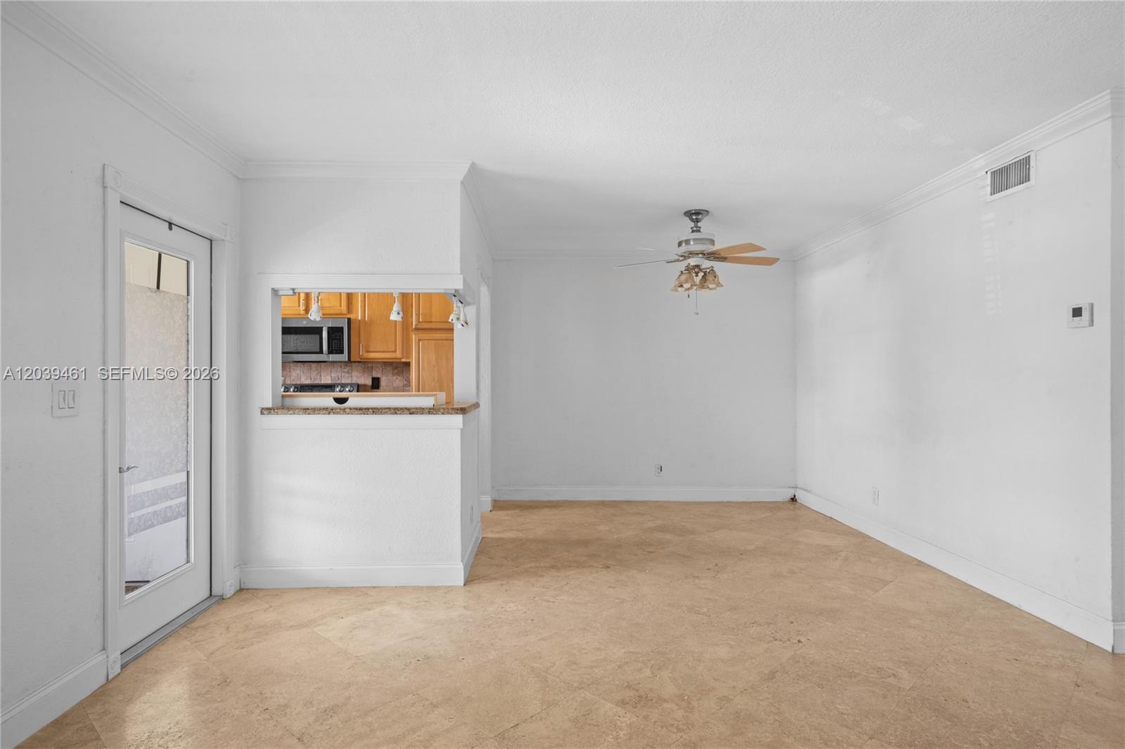 A dining area features tile flooring, a ceiling fan, and a pass-through to the kitchen — 541 Blue Heron Dr # 308, Hallandale Beach FL 33009, HALLANDALE BEACH, FL