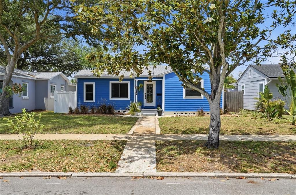 A blue single-story house with a white front door and a concrete walkway — 3145 8TH AVENUE N, ST PETERSBURG, FL