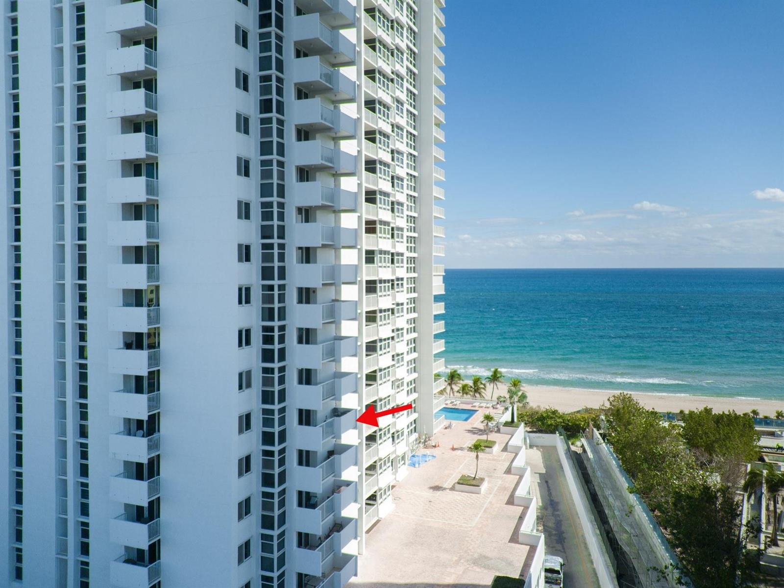 An aerial view of a white high-rise condominium building overlooking the ocean and beach — 1370 S Ocean Boulevard # 604, Pompano Beach FL 33062, POMPANO BEACH, FL
