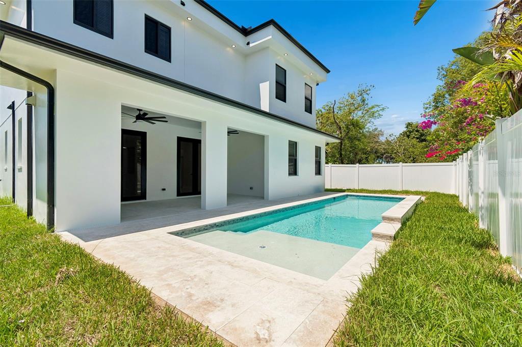 A modern white two-story house with a backyard swimming pool and a covered patio area — 4101 W MANGO AVENUE, TAMPA, FL