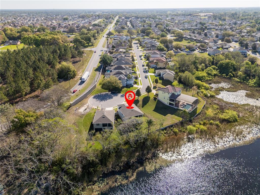 An aerial view shows a house with a red location pin near a lake — 356 CHEROKEE AVENUE, HAINES CITY, FL