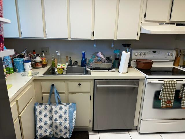 A kitchen features white cabinets, a stainless steel dishwasher, and a white electric range — 3186 Via Poinciana # 306, FL 33467, FL