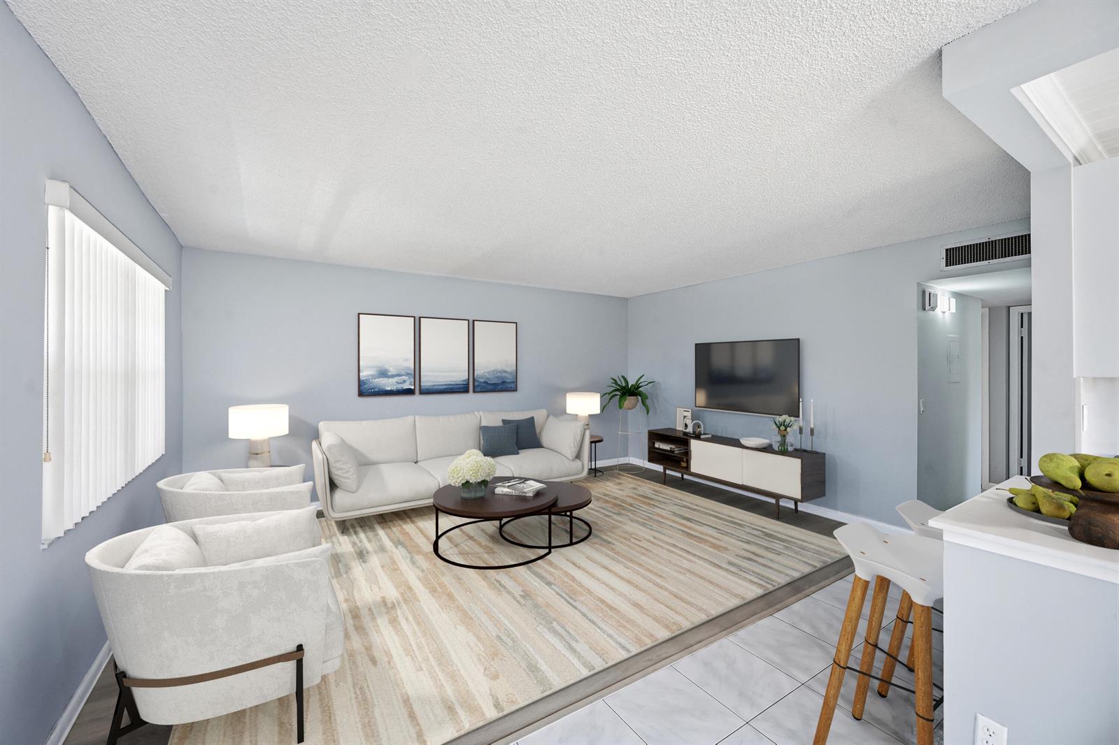 A living room features a white sofa, two armchairs, a coffee table, and a television — 422 Burgundy I, Delray Beach FL 33484, DELRAY BEACH, FL
