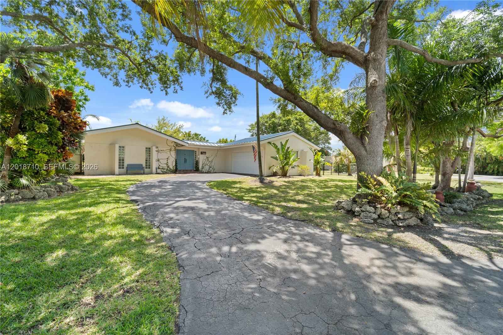 A rectangular swimming pool sits on a concrete patio beside a single-story house — 8380 SW 186 St, Cutler Bay FL 33157, CUTLER BAY, FL
