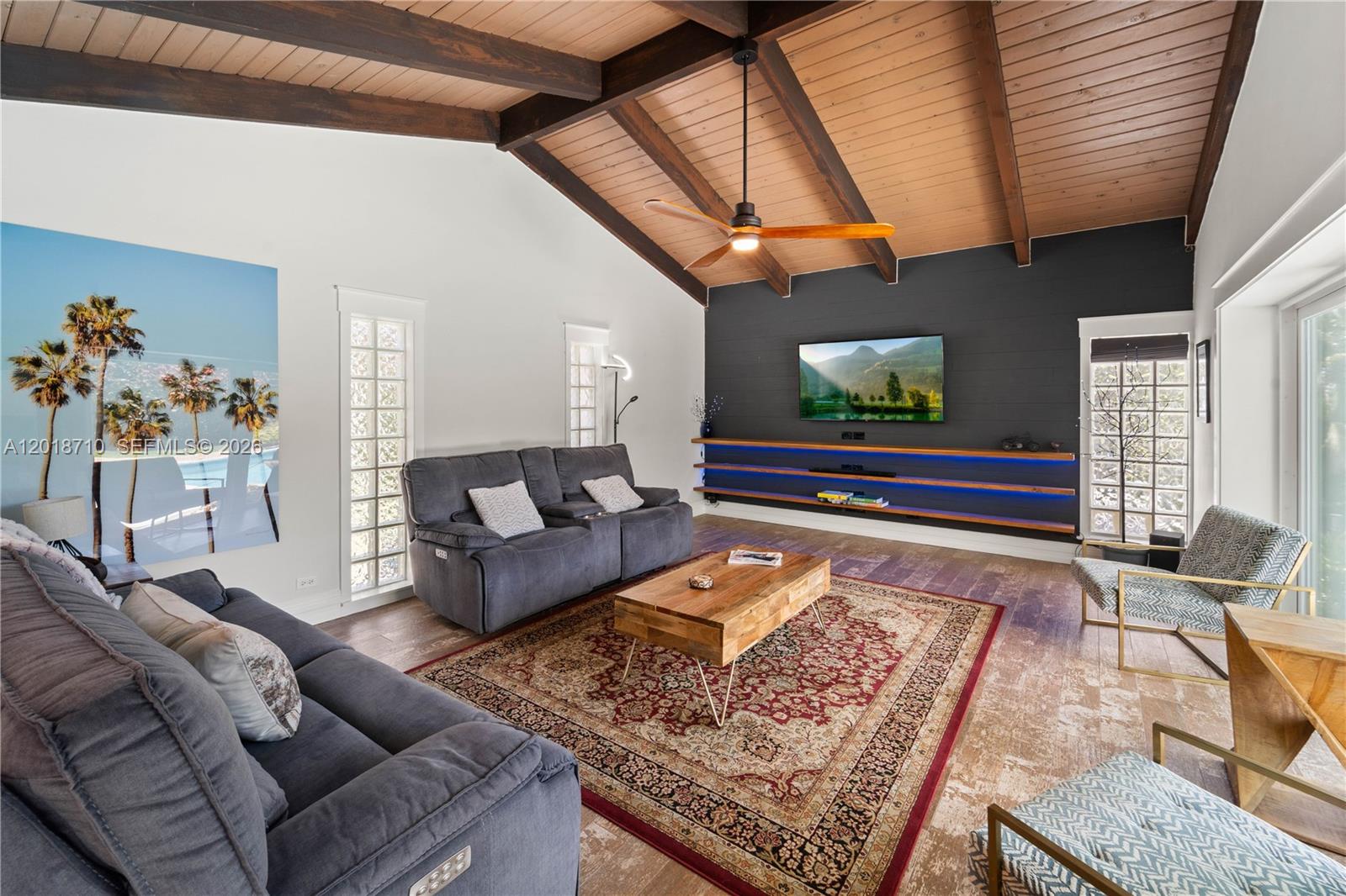 A living room features a vaulted wood ceiling, dark accent wall, and gray sofas — 8380 SW 186 St, Cutler Bay FL 33157, CUTLER BAY, FL