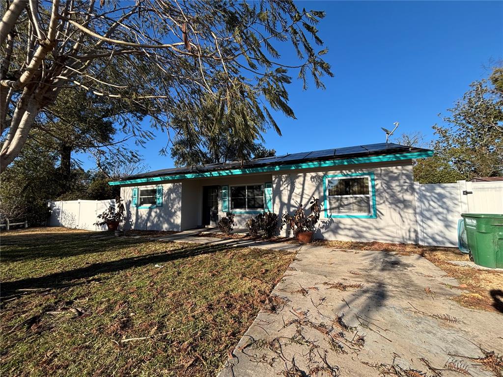 A kitchen features dark granite countertops, stainless steel appliances, and white cabinets — 710 EAST COURT, LONGWOOD, FL