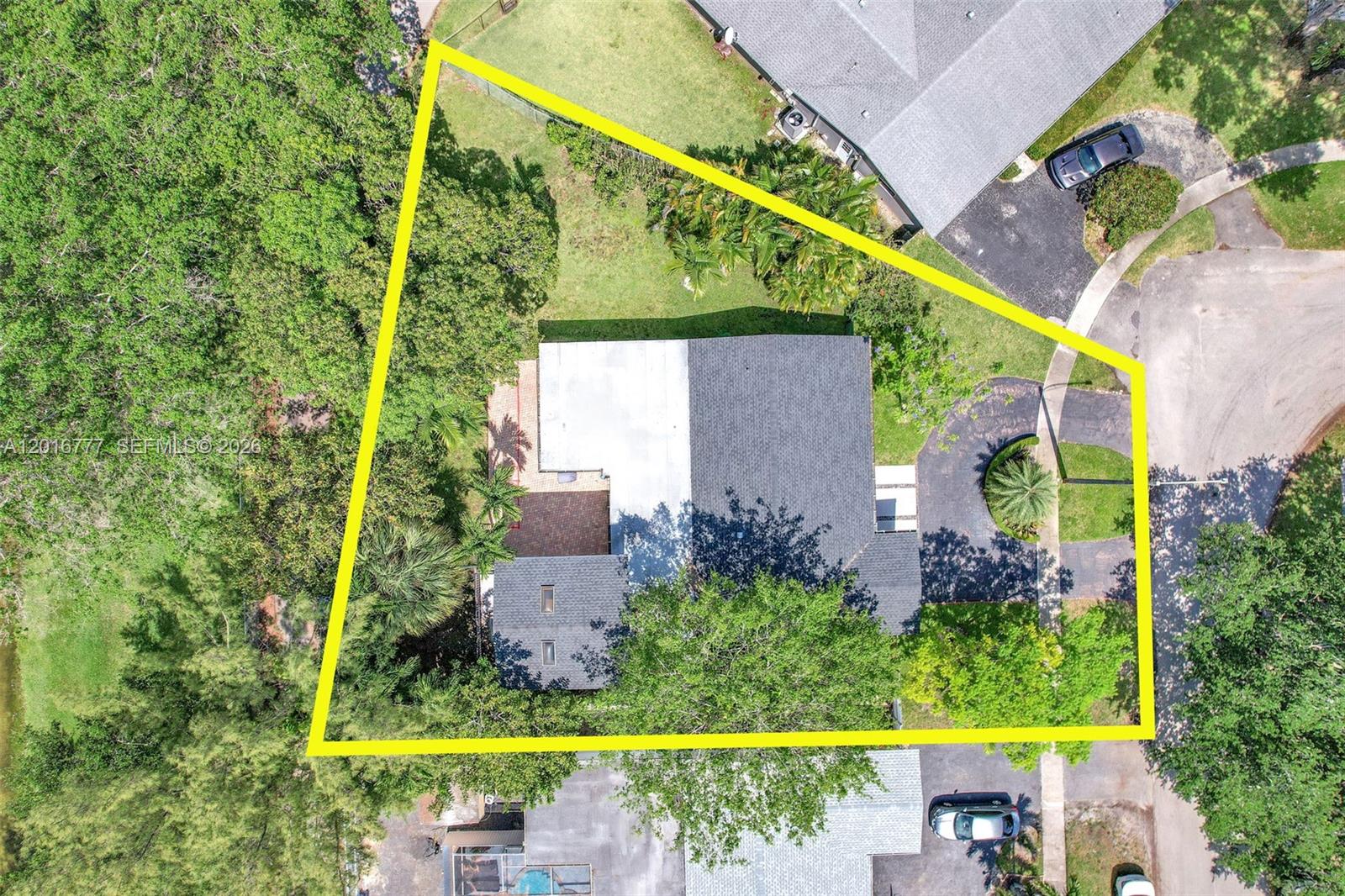 An aerial view shows a house with a dark roof on a triangular lot — 3411 Thomas St, Hollywood FL 33021, HOLLYWOOD, FL