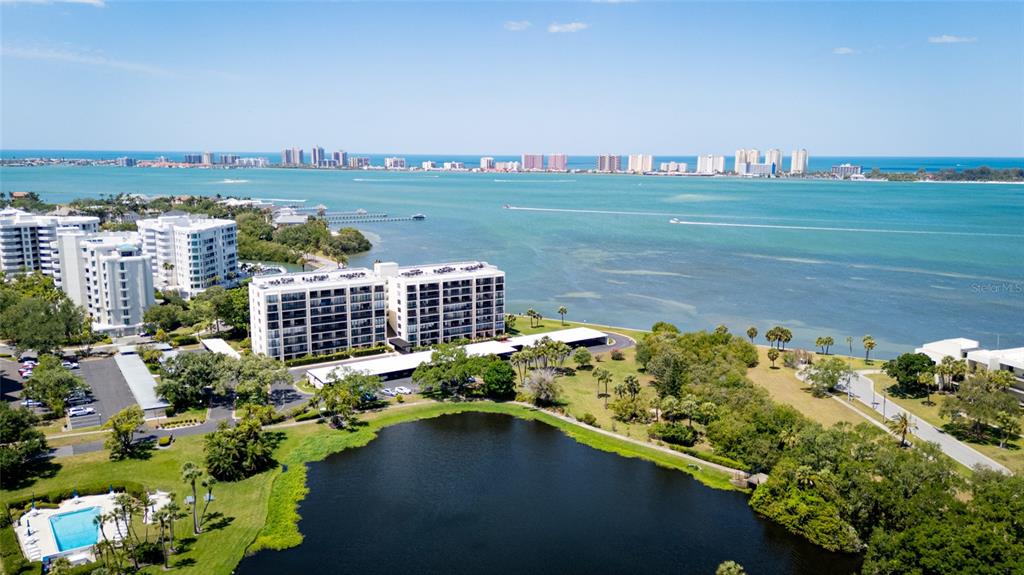 A kitchen features white cabinets, a granite countertop island, and tile flooring — 220 BELLEVIEW BOULEVARD UNIT 601, BELLEAIR, FL