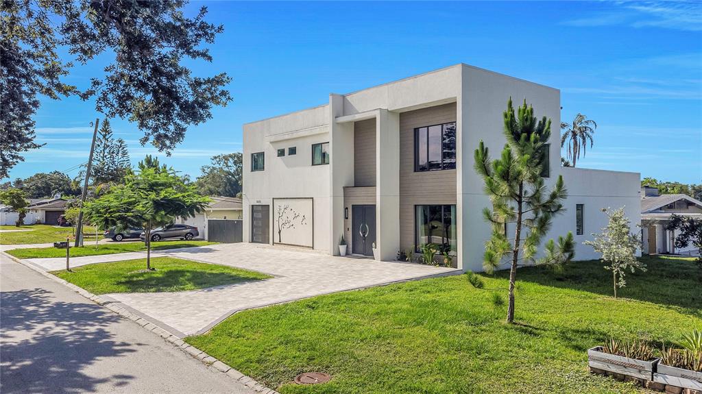 A modern two-story house with a white exterior, flat roof, and a paved driveway — 2635 WOODRING DR, CLEARWATER, FL