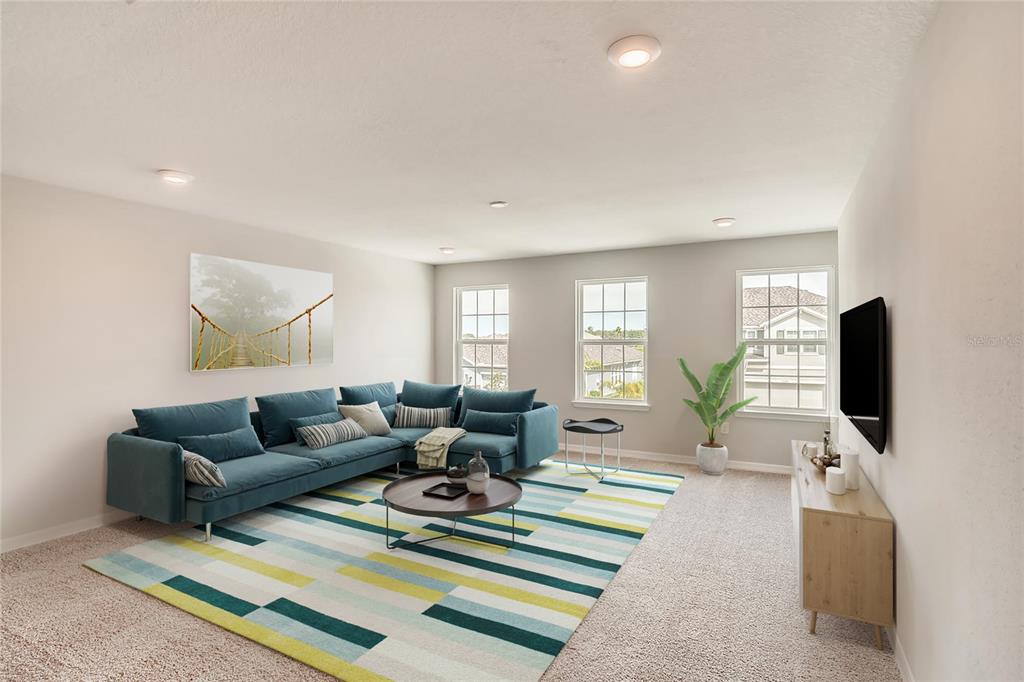 This is a digital rendering of a living room featuring a blue sectional sofa — 3529 LEMON BUTTON TERRACE, APOPKA, FL