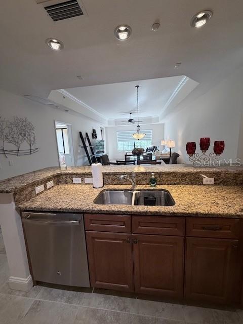 A kitchen with granite countertops and stainless steel appliances overlooks an open living area — 7710 LAKE VISTA COURT UNIT 302, LAKEWOOD RANCH, FL