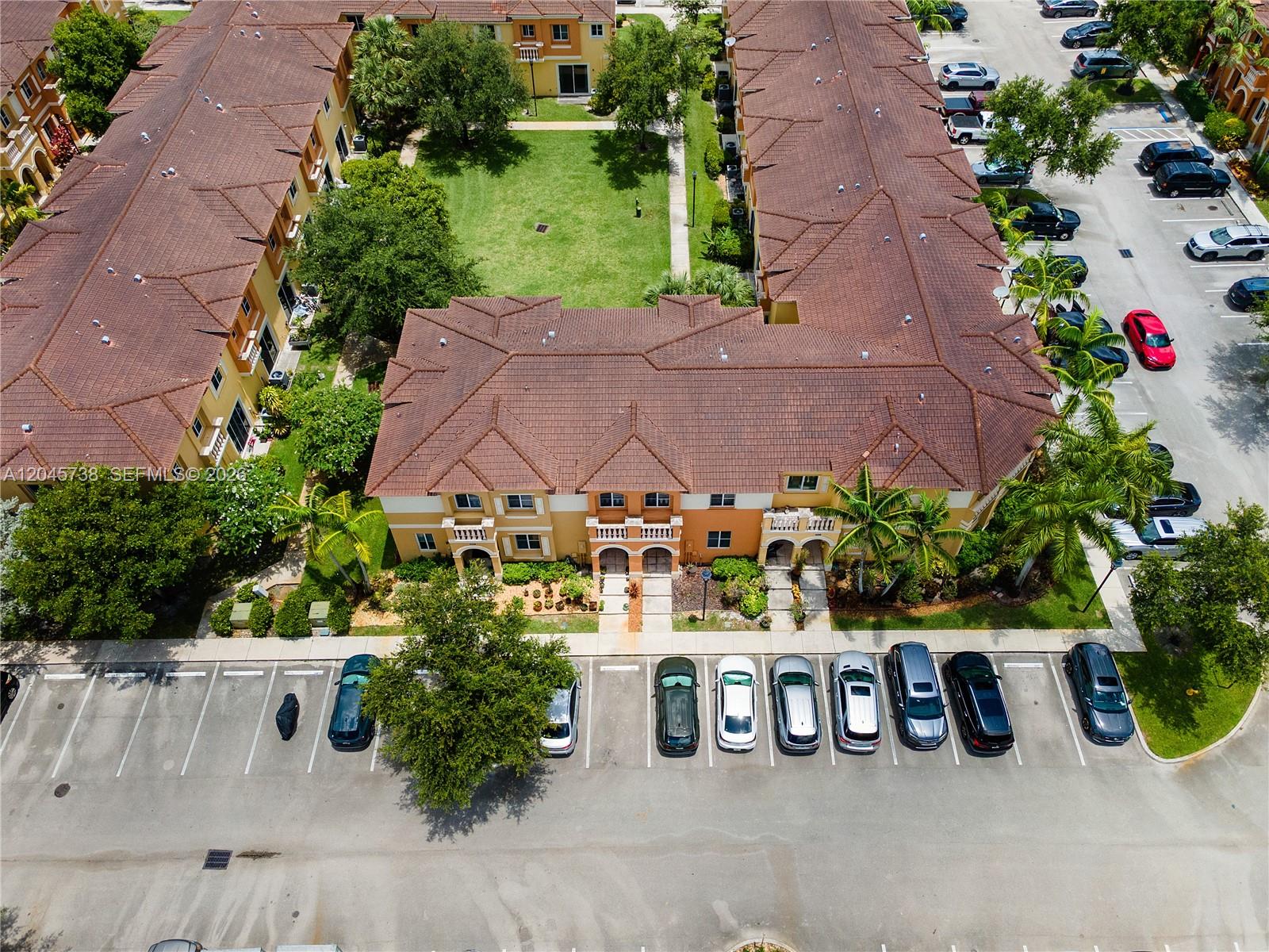 An aerial view shows a multi-story apartment complex with a central courtyard and parking lot — 8915 SW 19th St, Miramar FL 33025, MIRAMAR, FL
