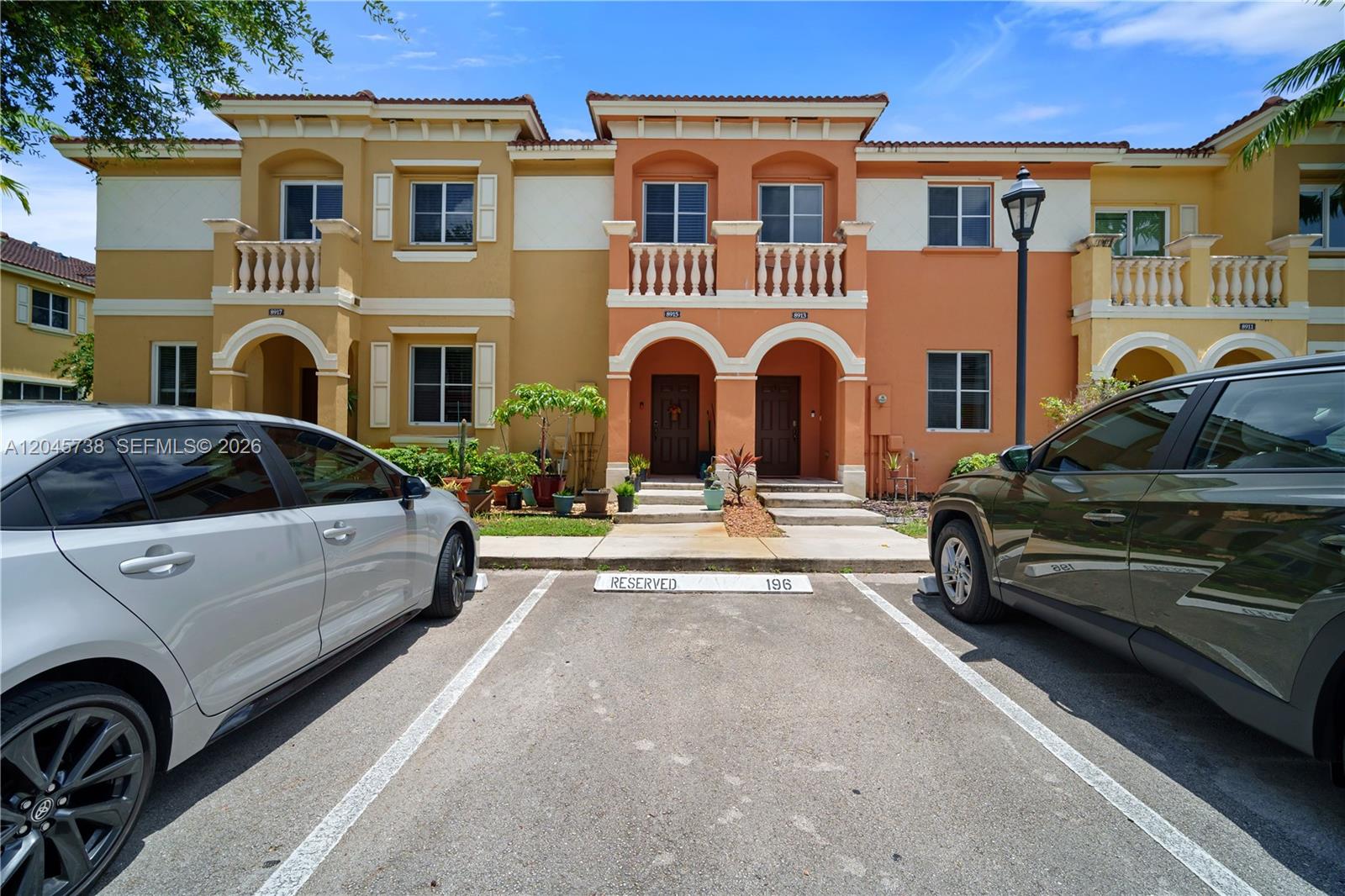 A view of townhouses with a reserved parking space in the foreground — 8915 SW 19th St, Miramar FL 33025, MIRAMAR, FL