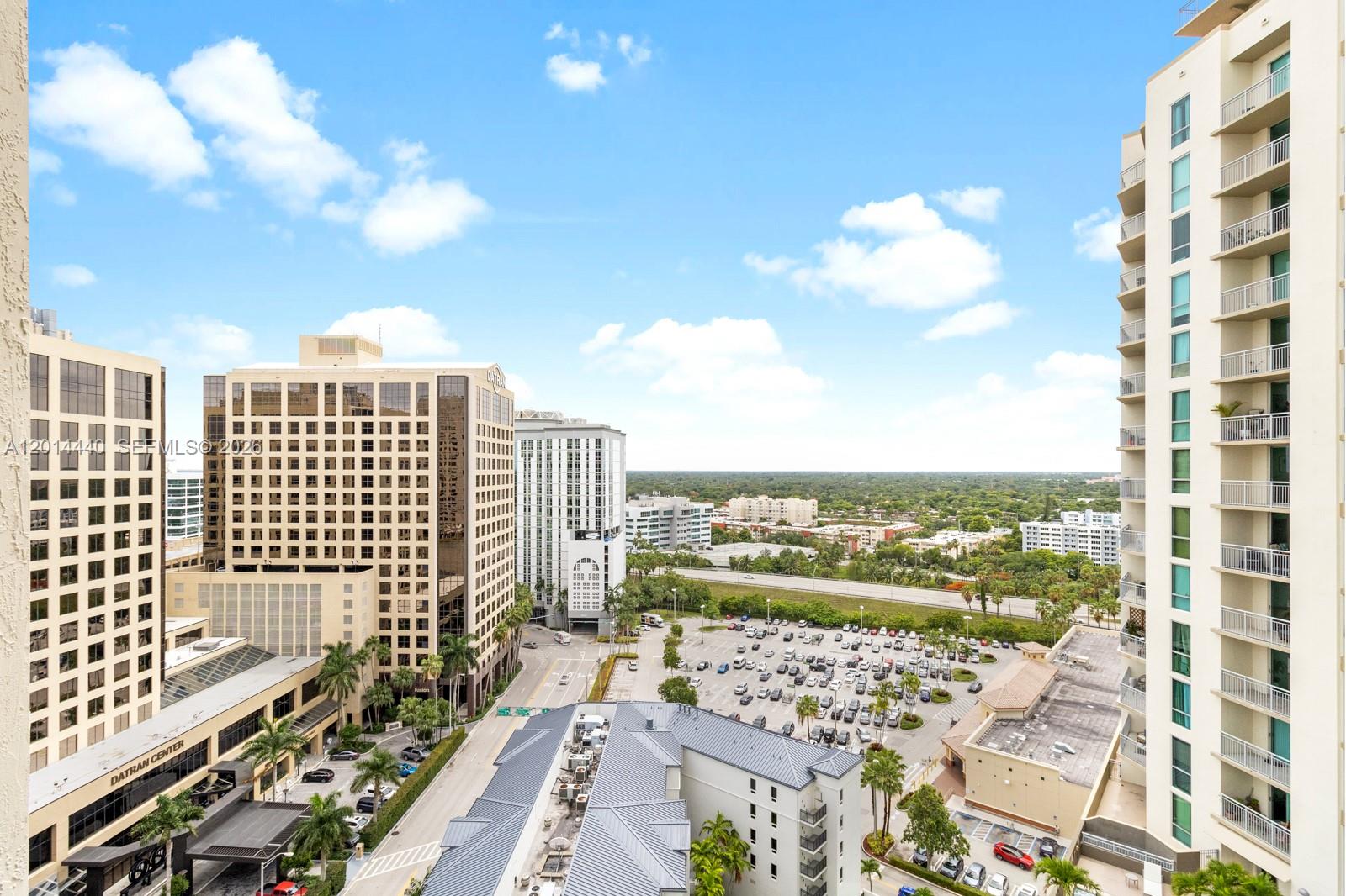 An elevated outdoor view shows a parking lot surrounded by office buildings and residential towers — 9055 SW 73rd Ct # 1506, Miami FL 33156, MIAMI, FL