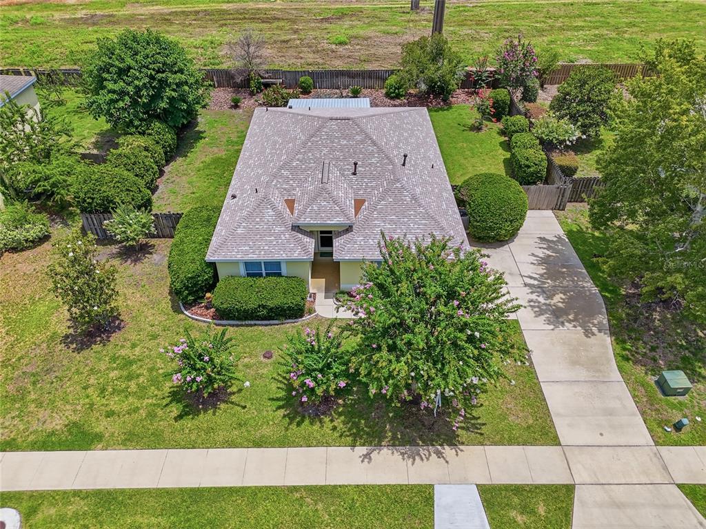 An aerial view of a single-story house with a shingled roof, driveway, and landscaped yard — 23152 NW 11TH ROAD, NEWBERRY, FL