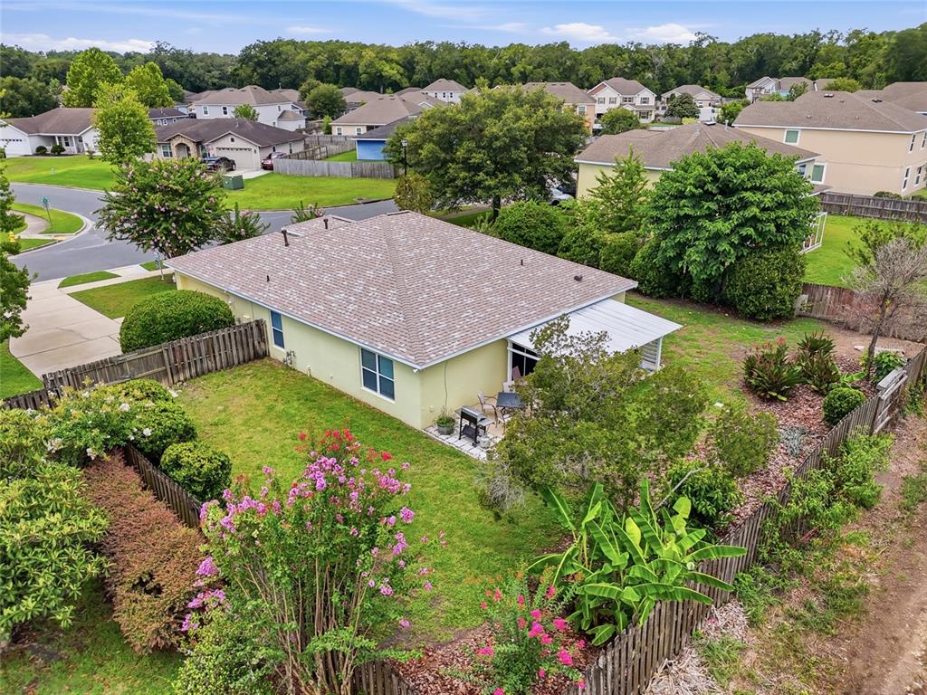 An aerial view of a single-story house with a fenced backyard and patio — 23152 NW 11TH ROAD, NEWBERRY, FL