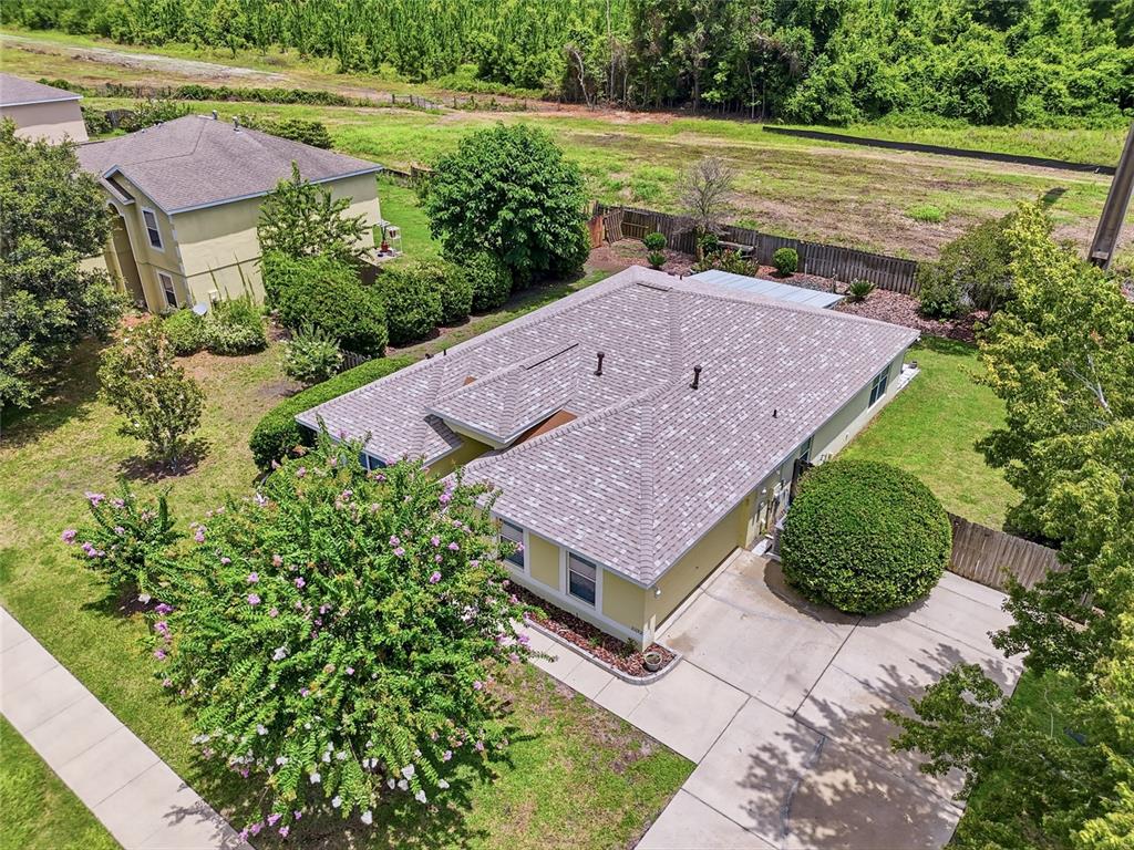 An aerial view shows a single-story house with a shingled roof and a concrete driveway — 23152 NW 11TH ROAD, NEWBERRY, FL