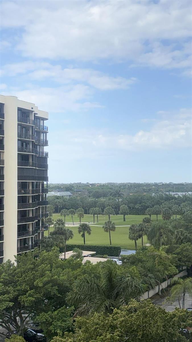 An exterior view from a high-rise balcony overlooking a golf course and surrounding trees — 2425 Presidential Way # 705, West Palm Beach FL 33401, WEST PALM BEACH, FL