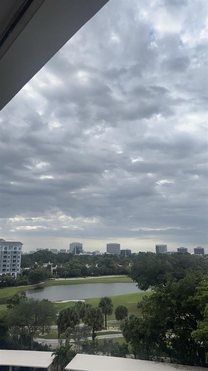 A view of a lake, golf course, and city skyline under a cloudy sky — 2425 Presidential Way # 705, West Palm Beach FL 33401, WEST PALM BEACH, FL