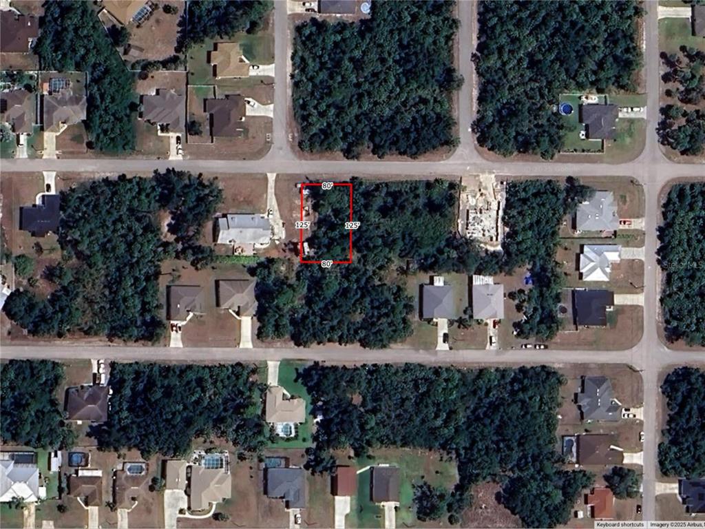 This aerial map shows a rectangular vacant lot highlighted in red within a residential neighborhood — LEESBURG AVENUE, NORTH PORT, FL