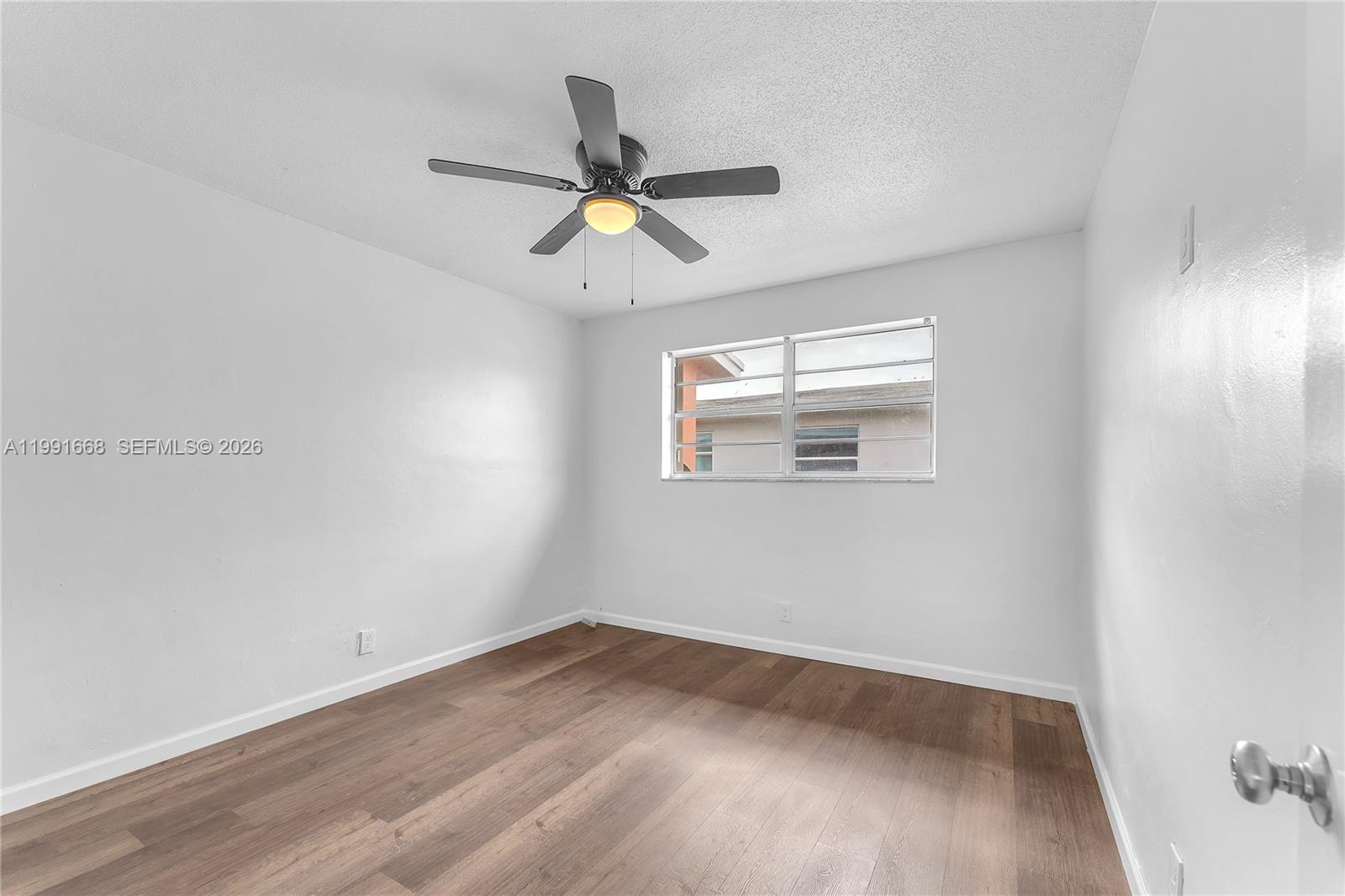 An empty bedroom features white walls, wood-look flooring, and a ceiling fan — 3750 SW 59th Ave # 3, Davie FL 33314, DAVIE, FL