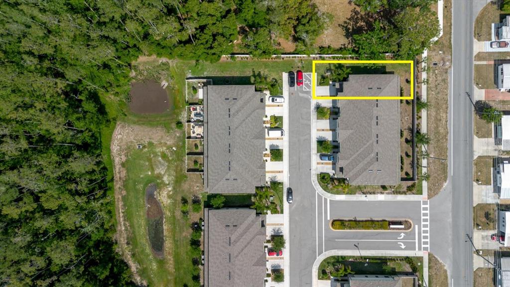 This aerial view shows a residential building complex with a highlighted unit and surrounding landscaping — 5226 FORUM BOULEVARD, HOLIDAY, FL