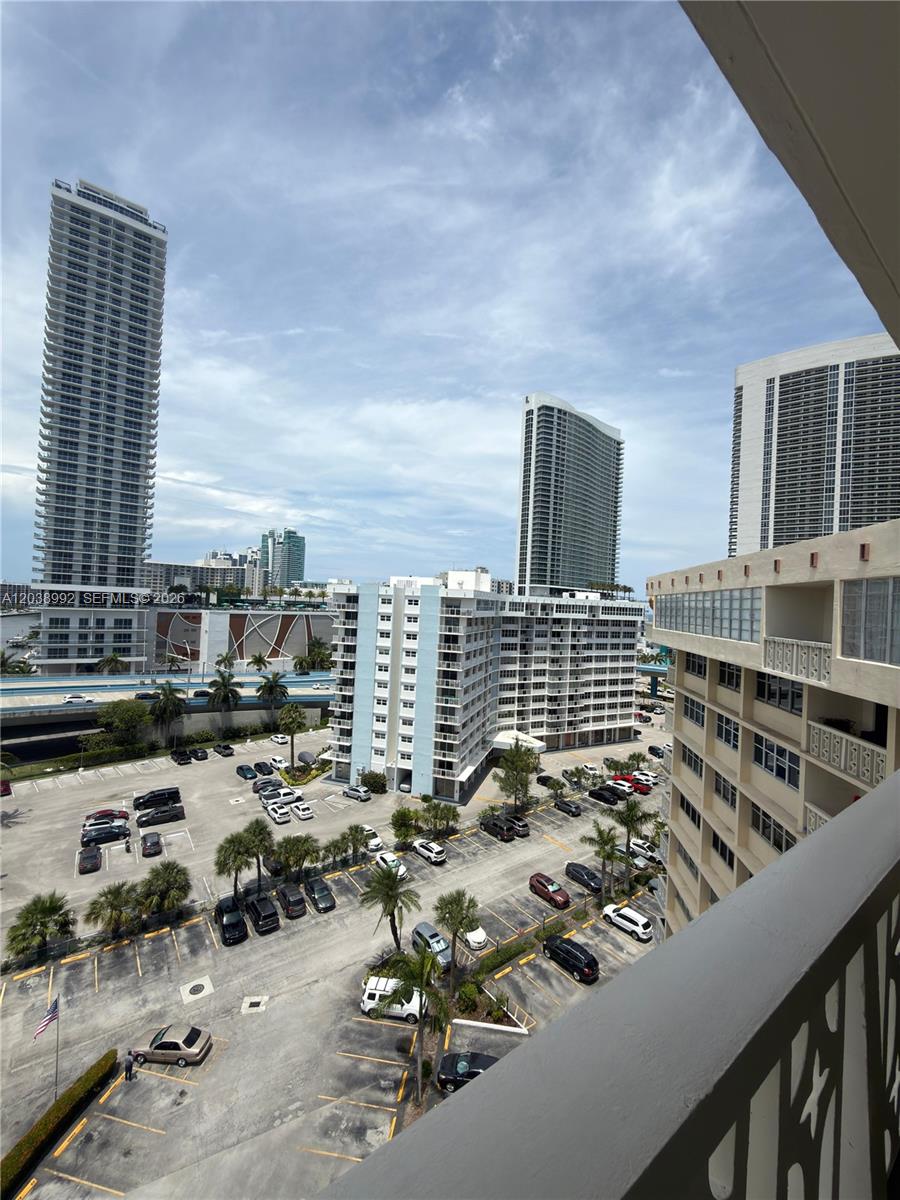 An elevated view of a parking lot surrounded by high-rise buildings under a cloudy sky — 1817 S Ocean Dr # 18, Hallandale Beach FL 33009, HALLANDALE BEACH, FL