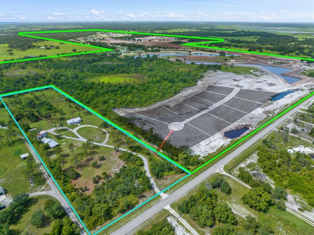 An aerial view shows a large plot of land with a house and cleared development area — 34452 SINGLETARY RD, MYAKKA CITY, FL