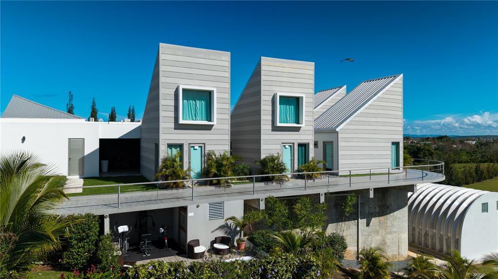 An exterior view of a modern house with three sloped roof sections and a balcony — 0 "CARRETERA 308 BARRIO MIRADERO", CABO ROJO, PR