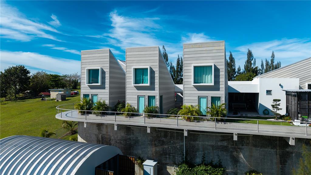 An exterior view of a modern house with three distinct, angled structures and a long balcony — 0 "CARRETERA 308 BARRIO MIRADERO", CABO ROJO, PR