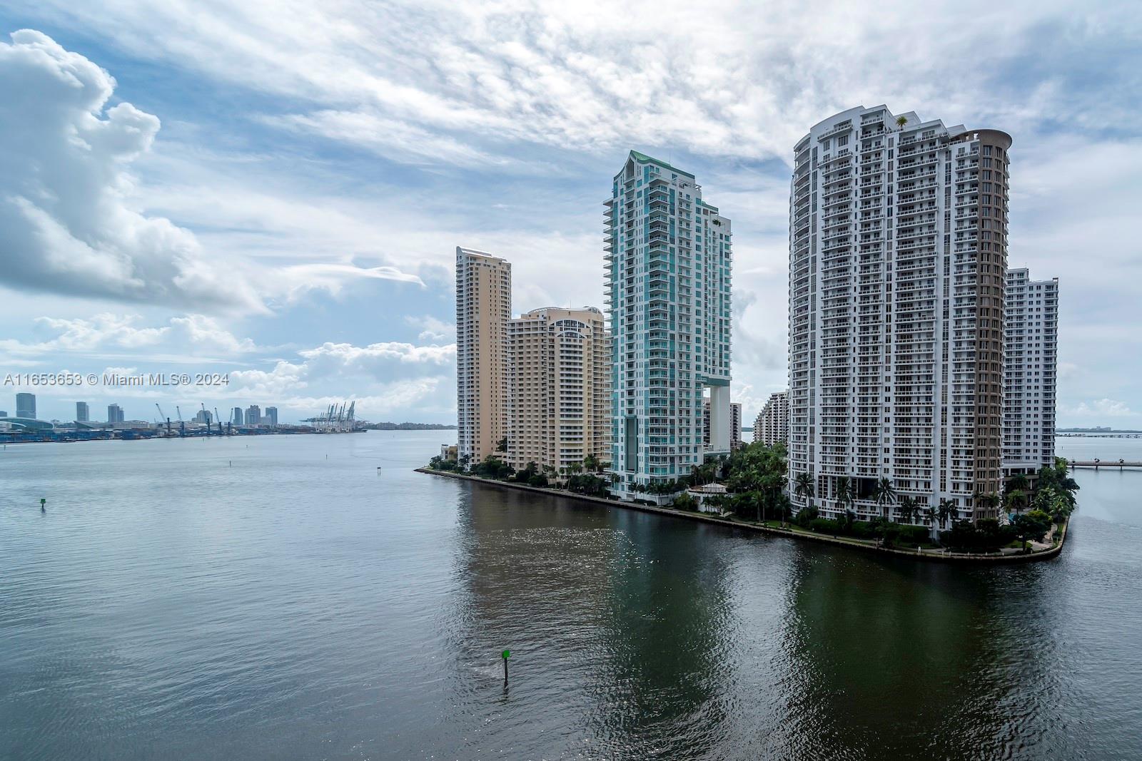 An aerial view shows several high-rise residential buildings situated on a point of land — 300 Biscayne Blvd Way # 902, Miami FL 33131, MIAMI, FL