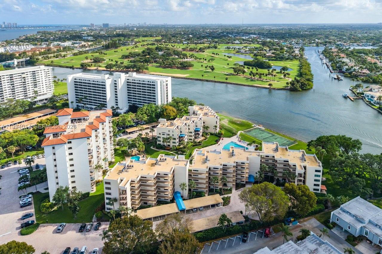 Aerial view of a waterfront condominium complex featuring a pool, tennis court, and golf course — 364 Golfview Rd # 505, North Palm Beach FL 33408, NORTH PALM BEACH, FL