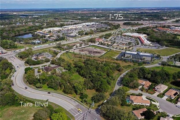 This is an aerial view of a vacant lot near a highway and shopping center — 5505 TARA PROFESSIONAL WAY, BRADENTON, FL