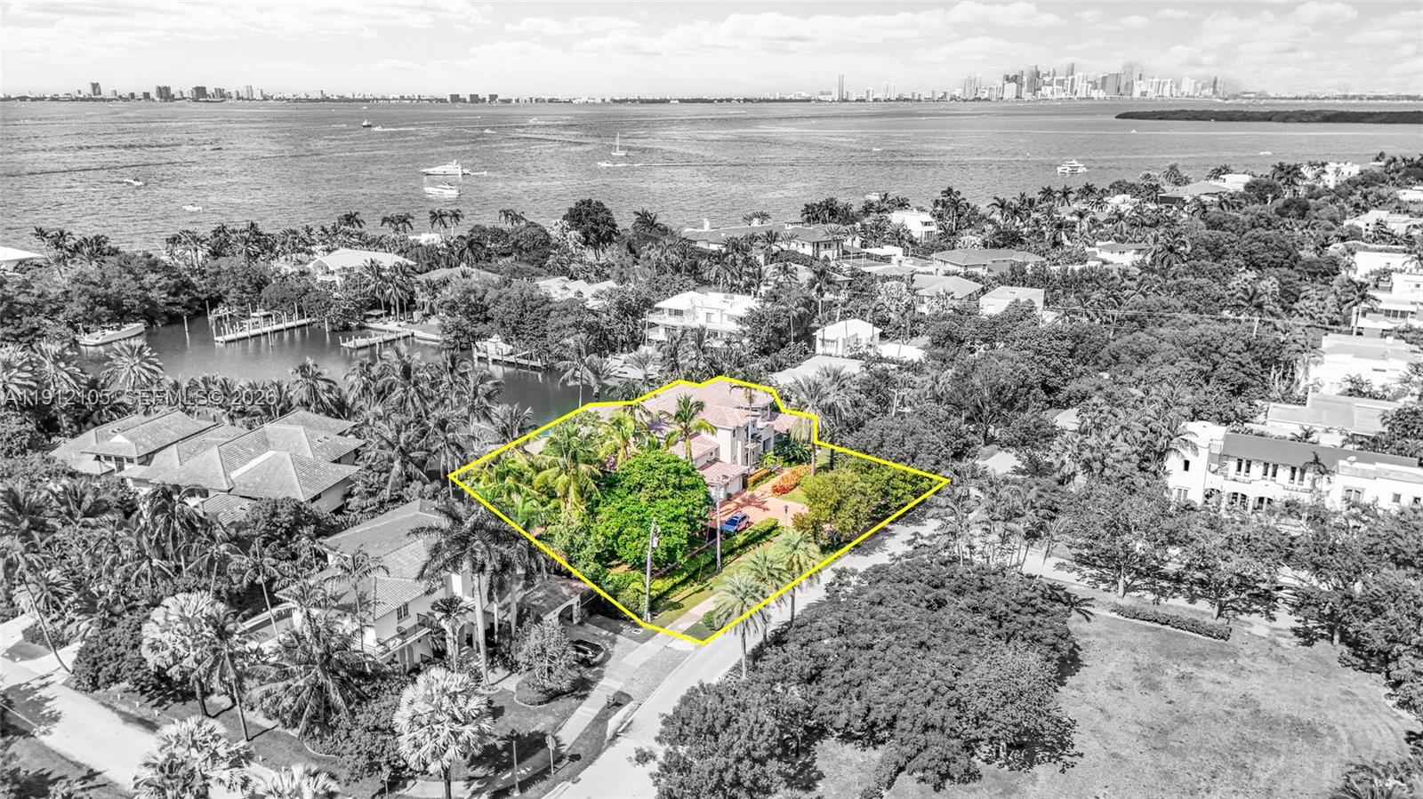 An aerial view shows a waterfront house with a pool, dock, and several boats — 550 Harbor Dr, Key Biscayne FL 33149, KEY BISCAYNE, FL