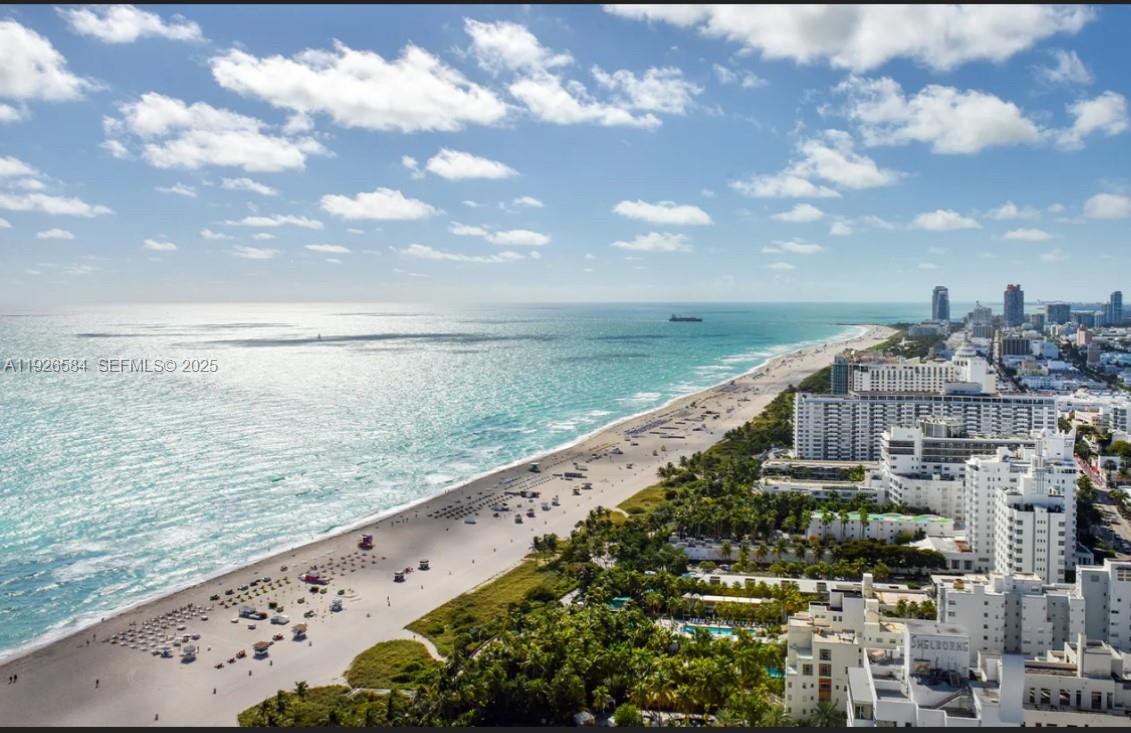 An aerial view of a sandy beach coastline with high-rise buildings and the ocean — 101 20th St # 3202, Miami Beach FL 33139, MIAMI BEACH, FL