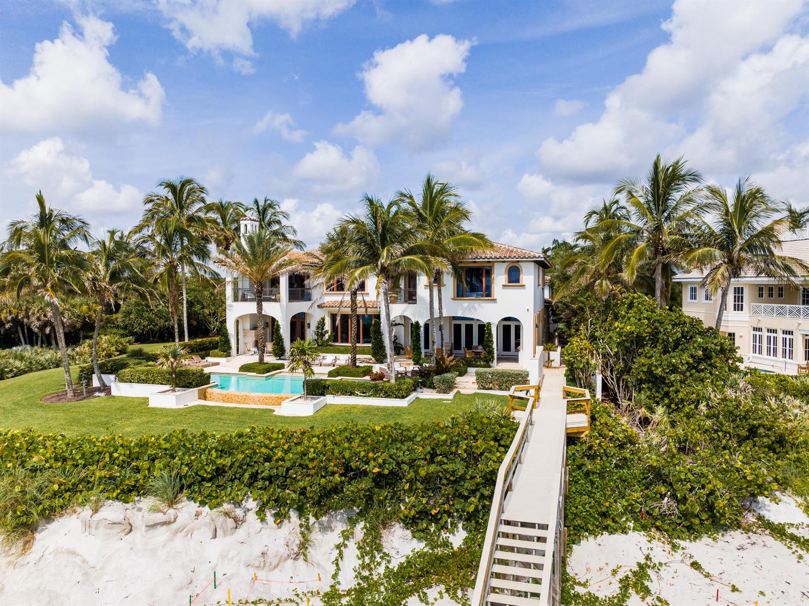 An aerial view of a white multi-story house with a pool and a beach walkway — 10 Ocean Lane, Vero Beach FL 32963, VERO BEACH, FL