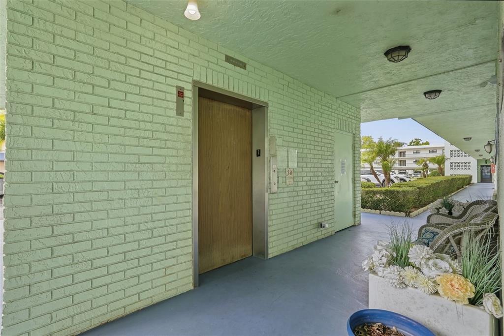 A hallway features a wall of metal mailboxes, a bulletin board, and a framed picture — 5973 TERRACE PARK DRIVE N UNIT 109, ST PETERSBURG, FL
