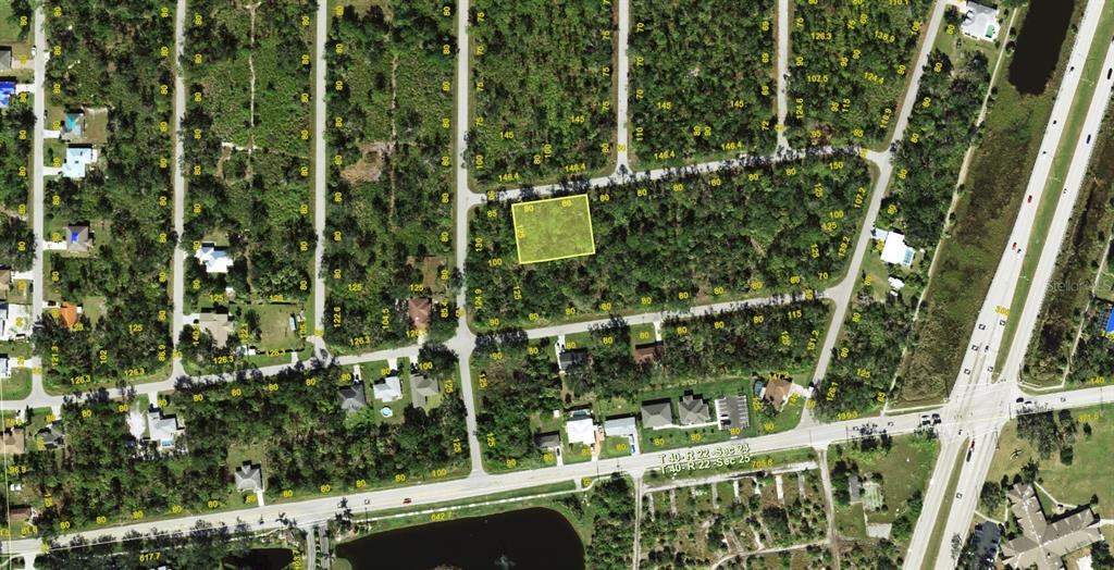 This is an aerial map showing a vacant, rectangular lot highlighted in yellow — 23149 KELLETT AVENUE, PUNTA GORDA, FL