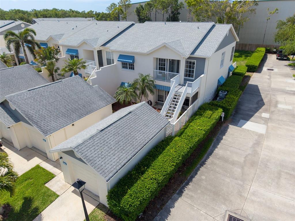 An aerial view shows a two-story townhouse with a detached garage and a hedge-lined driveway — 11531 SHIPWATCH DRIVE UNIT 1037, LARGO, FL