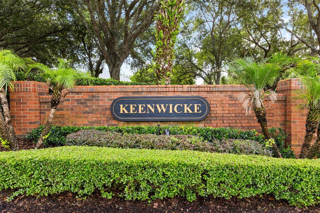 A brick wall with a Keenwicke sign stands behind a manicured hedge and palm trees — 1154 KERSFIELD CIRCLE, LAKE MARY, FL