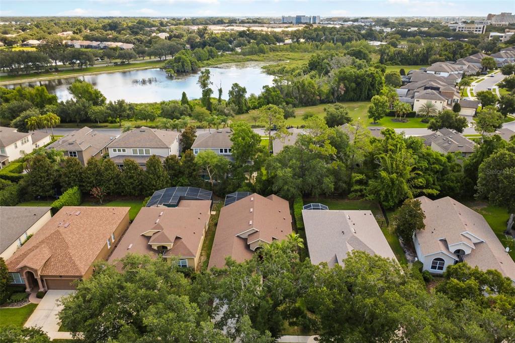 An aerial view shows several suburban houses with swimming pools and a nearby pond — 1154 KERSFIELD CIRCLE, LAKE MARY, FL