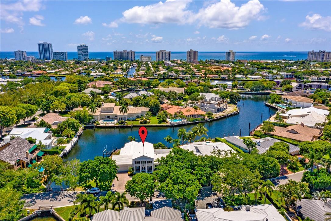 An aerial view shows a white house with a red map pin on a canal — 2 Compass Lane, Fort Lauderdale FL 33308, FORT LAUDERDALE, FL