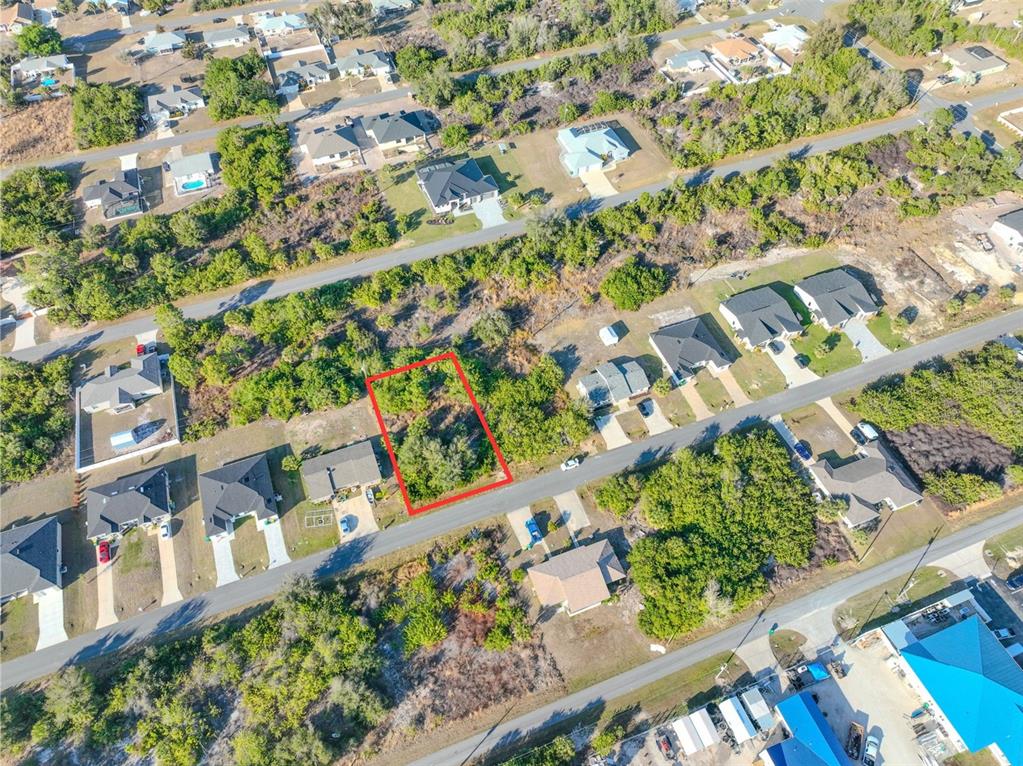 An aerial view shows a vacant, rectangular lot outlined in red within a residential neighborhood — 11200 KIMBERLY AVENUE, ENGLEWOOD, FL