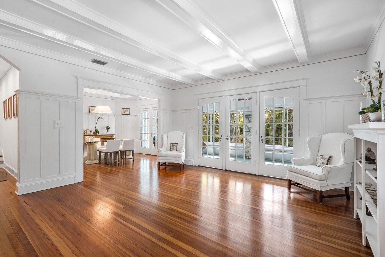 A bright living room with white wainscoting, coffered ceilings, and polished hardwood floors — 141 Chilean Avenue, Palm Beach FL 33480, PALM BEACH, FL