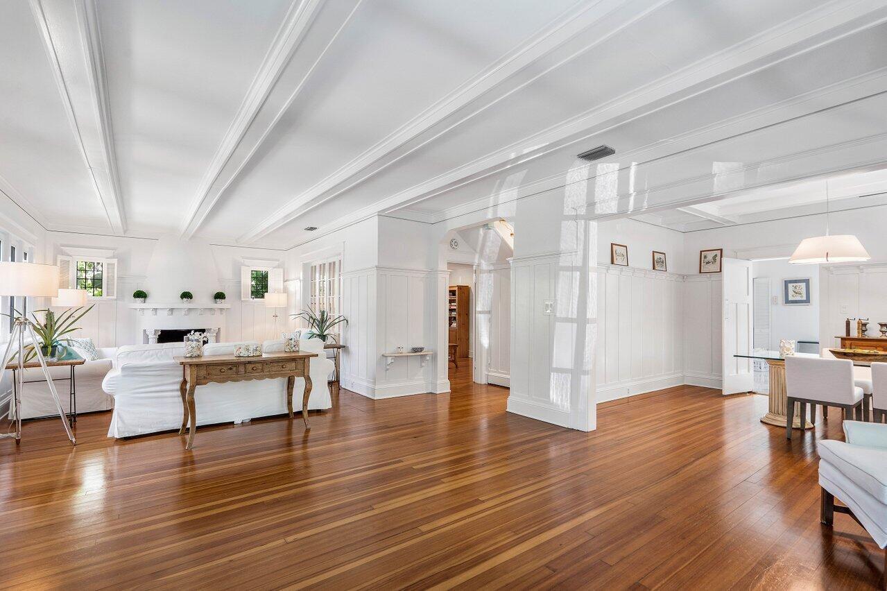 A bright living and dining area with white walls, coffered ceilings, and polished hardwood floors — 141 Chilean Avenue, Palm Beach FL 33480, PALM BEACH, FL