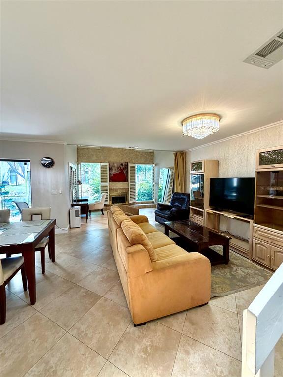 A living room features tile flooring, a tan sofa, a television, and a dining area — 6075 GLENDALE DRIVE, BOCA RATON, FL