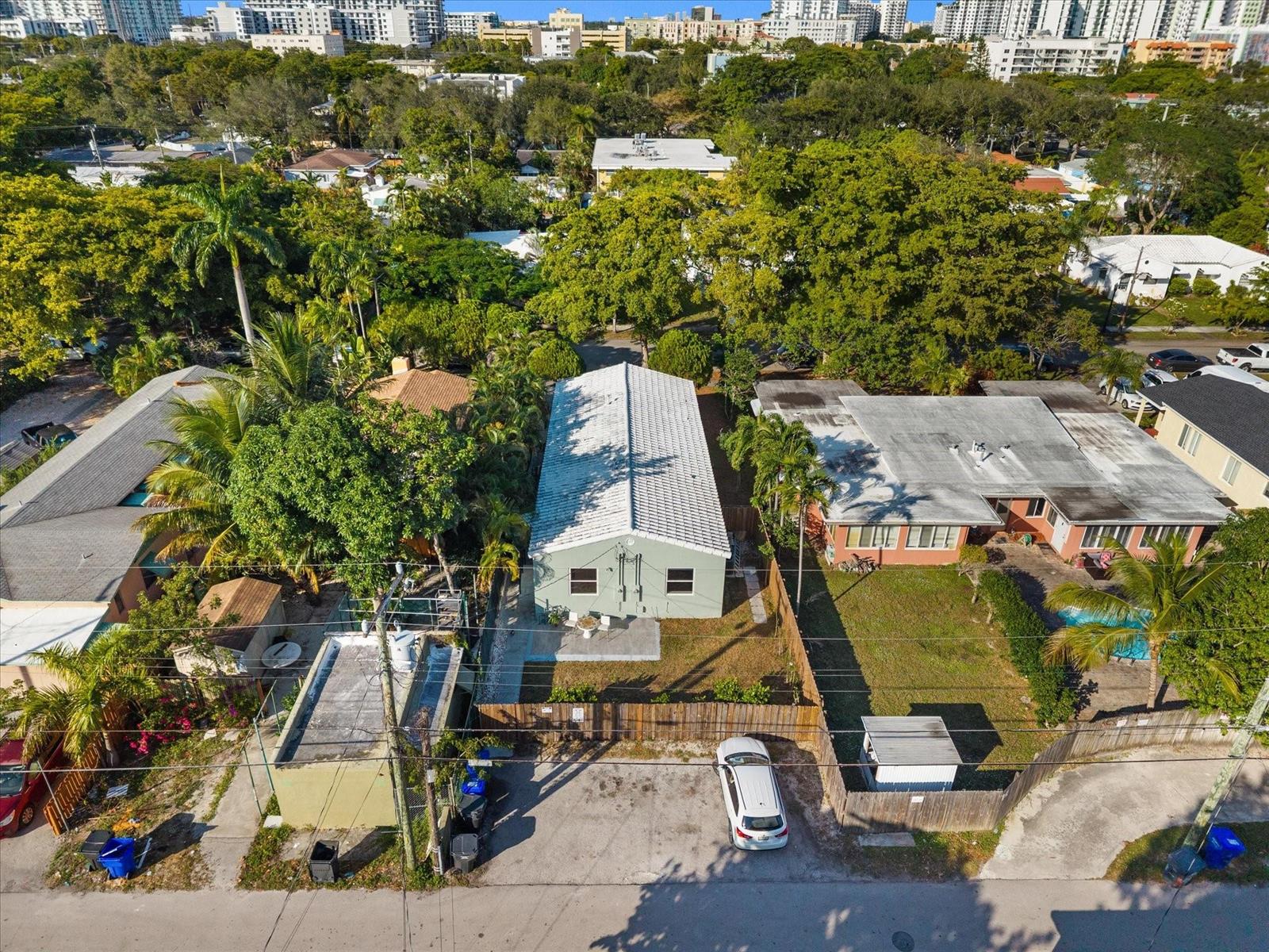 An aerial view shows a light green house with a white roof and a parking area — 1928 Adams Street, Hollywood FL 33020, HOLLYWOOD, FL