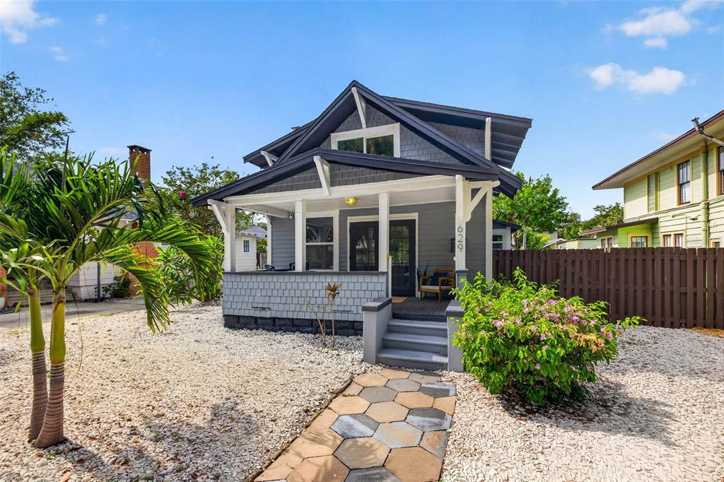 A gray bungalow with a front porch, shingle siding, and a stone walkway — 629 6TH AVENUE N, ST PETERSBURG, FL